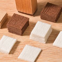 several pieces of wood sitting on top of a wooden table next to a rubber block