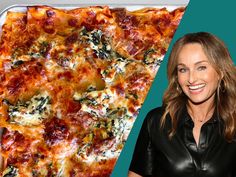 a woman standing next to a large pizza in a pan with cheese and spinach on it