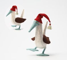 two stuffed birds wearing red and white hats