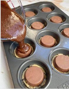 chocolate cupcakes in a muffin tin being filled with batter