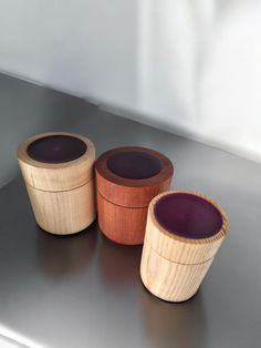 three wooden containers sitting on top of a table