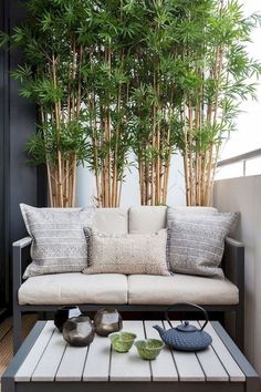 a couch sitting on top of a wooden floor next to a table with two bowls