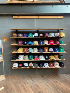 the hat rack is full of hats in various colors and sizes, along with other items