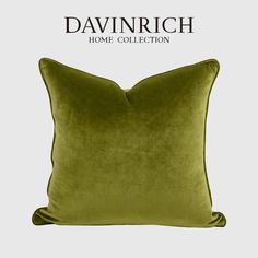 a green velvet pillow with the words, davinrich home collection