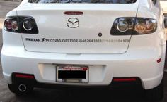 the back end of a white mazda car