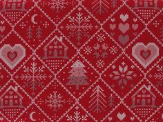 a red and white knitted christmas sweater with hearts, trees, snowflakes and houses