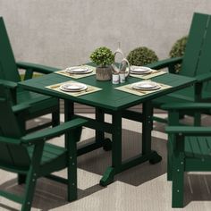 a green table and chairs with plates on them