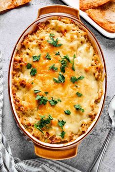 a casserole dish with cheese and herbs