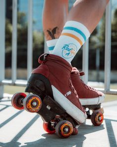 a person riding a skateboard with red and white shoes