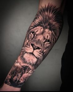 a man's arm with a lion tattoo on it