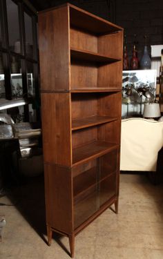 a tall wooden shelf sitting inside of a kitchen