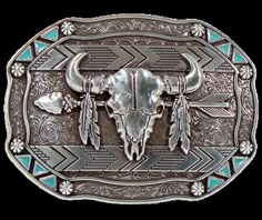 This belt buckle takes inspiration from the Lakota people, known for their buffalo hunting practices. It features an oval shape with small turquoise triangles and berry shapes along the border. In antique silver, it showcases a buffalo skull, feathers, and an arrow in the center. Measuring approximately 3 tall by 4 wide, it can fit belts up to 1 1/2 wide. You can find it in our retail shop in Smyrna, TN, near Nashville, or on our online store. Western Picture Frames, Feather Arrow, Belt Clips, Smith And Western, Western Sculpture, Western Rings, Western Bracelets, Western Prints, Buffalo Skull