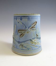 a blue and white cup with a dragonfly on it