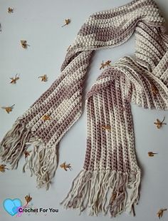 two scarves are laying on top of each other with bees flying around them in the background