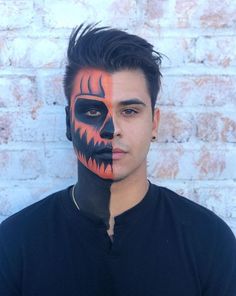 a man with his face painted to look like a scary jack - o - lantern