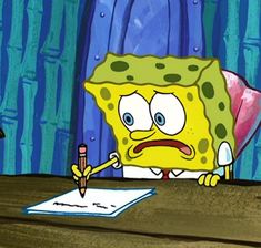 the spongebob is sitting at his desk with a pen and paper