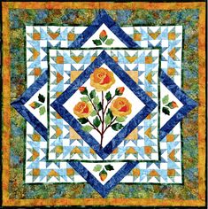 a quilted wall hanging with orange roses on it