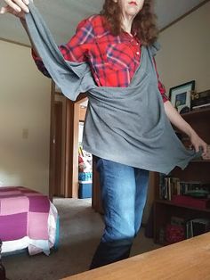 a woman standing in the middle of a living room with her arms spread wide open