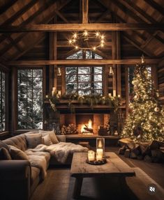 a living room filled with furniture and a christmas tree in front of a fire place