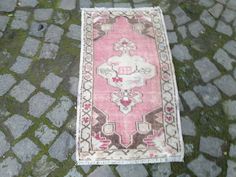 a pink rug is laying on the ground