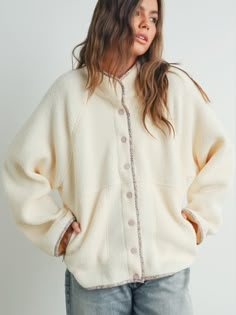 Cozy up in our Liza Sherpa Jacket! This super functional mock neck jacket features snap buttons, floral trim, and pale pink buttons for a feminine touch. Stay warm and stylish all winter long with this super chic piece. Material 100% Polyester ships within 2 weeks Sherpa Fleece Jacket, Cute Coats, Long Sleeve Outerwear, Crop Top Sweatshirt, Cute Jackets, Cold Weather Outfits, Sherpa Jacket, Cozy Chic, White Jacket