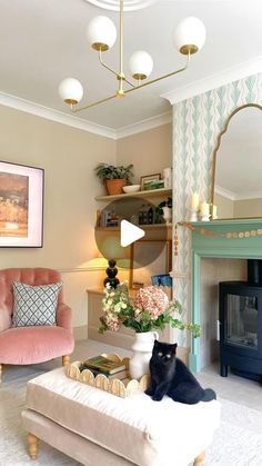 a living room filled with furniture and a cat sitting on top of a ottoman next to a fire place