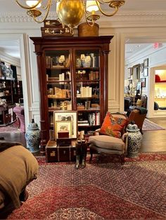 a living room filled with furniture and a chandelier