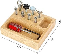 a wooden holder with screws, nuts and other tools in it on a white background