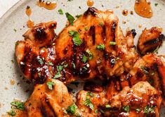 grilled chicken with sauce and herbs on a plate