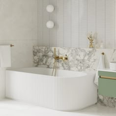 a white bath tub sitting next to a wall mounted faucet in a bathroom