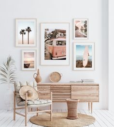 a living room with pictures on the wall and a wooden table in front of it