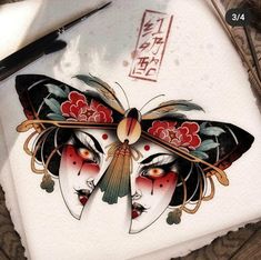 a drawing of a butterfly on top of a piece of paper next to a pair of scissors