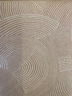 an intricately designed wallpaper with circles and dots in brown, white or beige