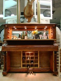 an old fashioned bar with a deer head on the top and wine bottles below it