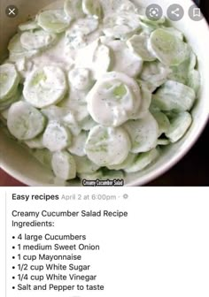 a bowl filled with cucumber salad on top of a table