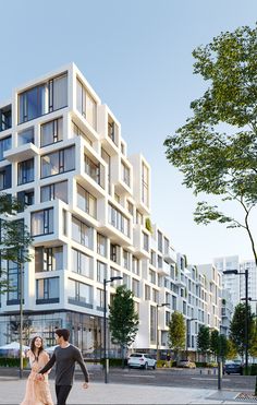 a man and woman are walking in front of a large white building with balconies