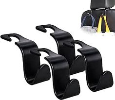 three black car seat holders with yellow handles