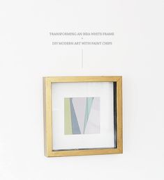 a white wall with a wooden frame hanging on it's side