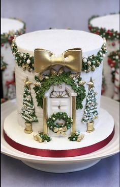 a white cake decorated with christmas decorations and a clock on it's side, sitting on a plate