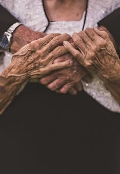 an older woman holding her hands together