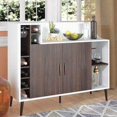 a white and brown cabinet with wine bottles on it