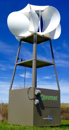 a large white object sitting on top of a lush green field next to a blue sky