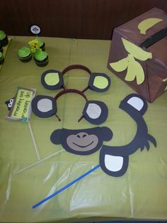 there is a monkey cut out on the table with cupcakes and other decorations