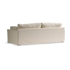 a white couch with two pillows on it