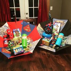 two open umbrellas sitting on top of a wooden table covered in toys and decorations