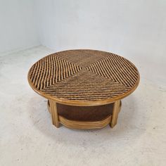 a coffee table made out of wicker with an unusual design on the top and bottom