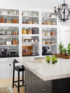 a kitchen filled with lots of open shelves