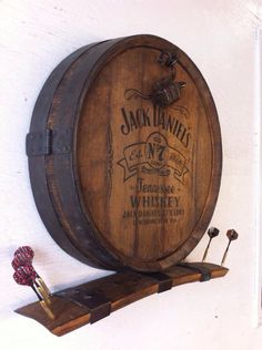 a wooden barrel sitting on top of a shelf next to a wall mounted wine opener