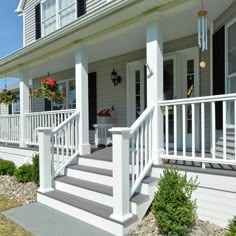 the front porch of a house with white railings