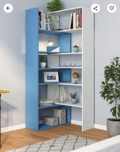 a blue and white bookshelf in a room next to a potted plant